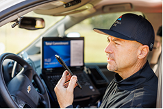 worker using phone in car